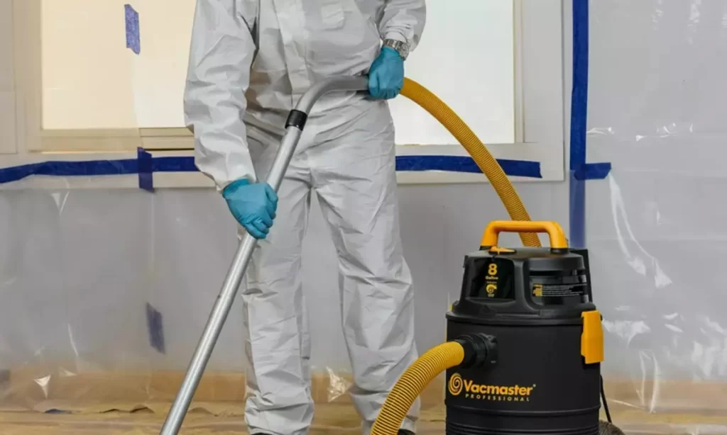 person cleaning the surface with vaccuum
